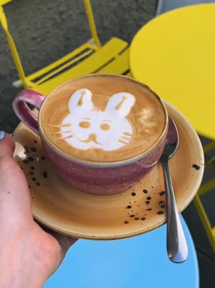 Latte art shaped like a rabbit in a pink cup